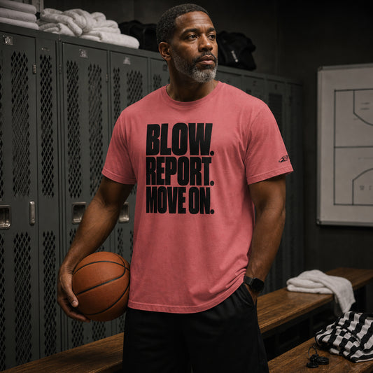 Basketball referee in a locker room holding a ball, wearing the Crimson Ref' Crew Blow. Report. Move On. Tee
