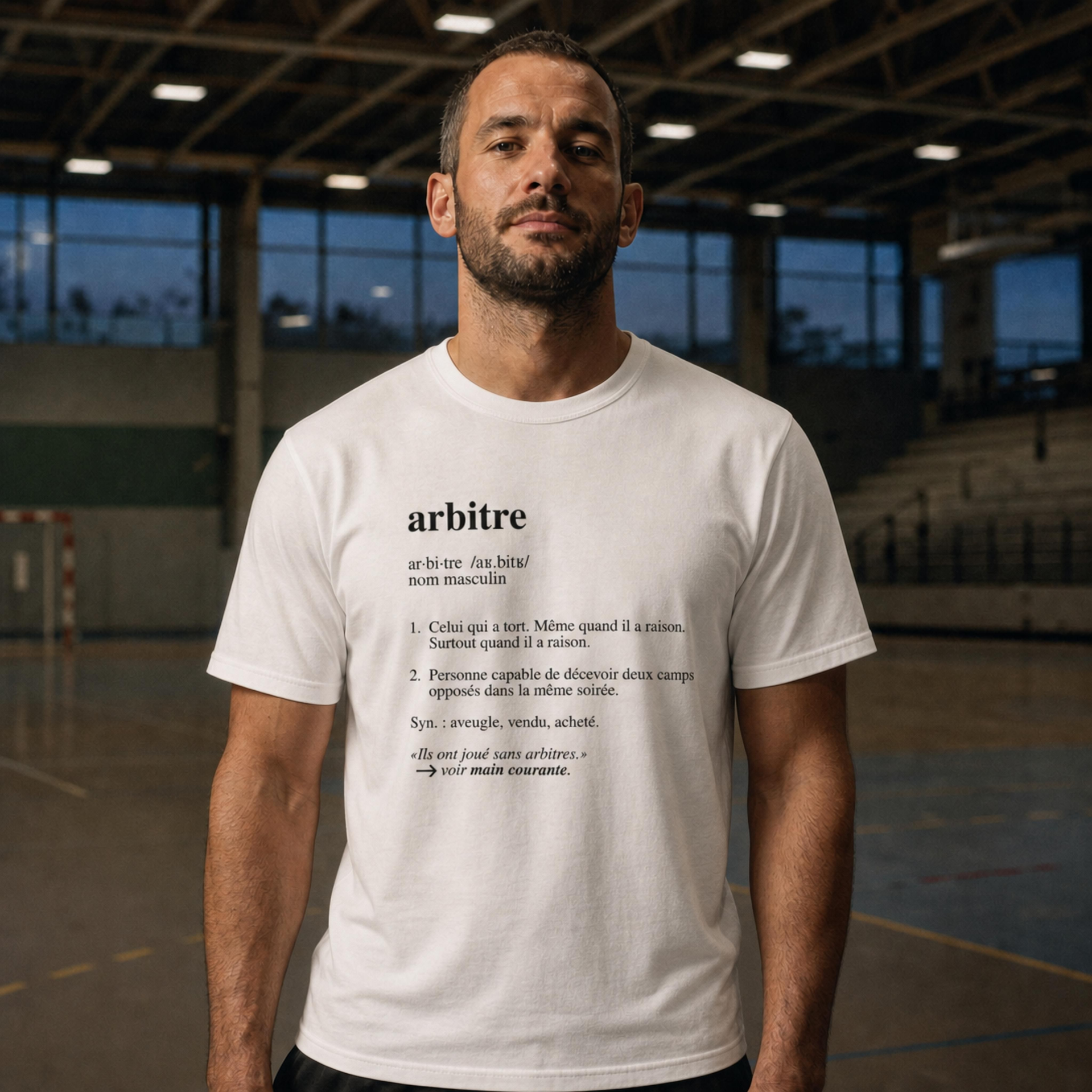 Referee wearing the Ref' Crew "Arbitre (Définition)" tee in White inside an empty sports hall