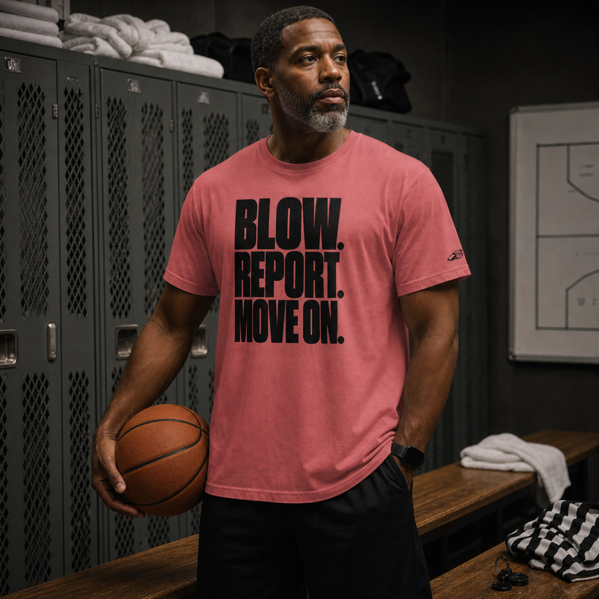 Basketball referee in a locker room holding a ball, wearing the Crimson Ref' Crew Blow. Report. Move On. Tee