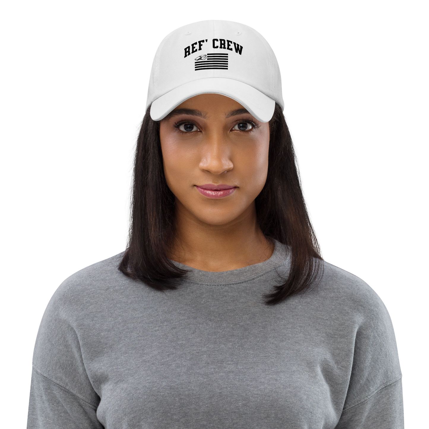 Woman wearing a white American Crew dad hat with "REF' CREW" and a whistle/basketball flag design.