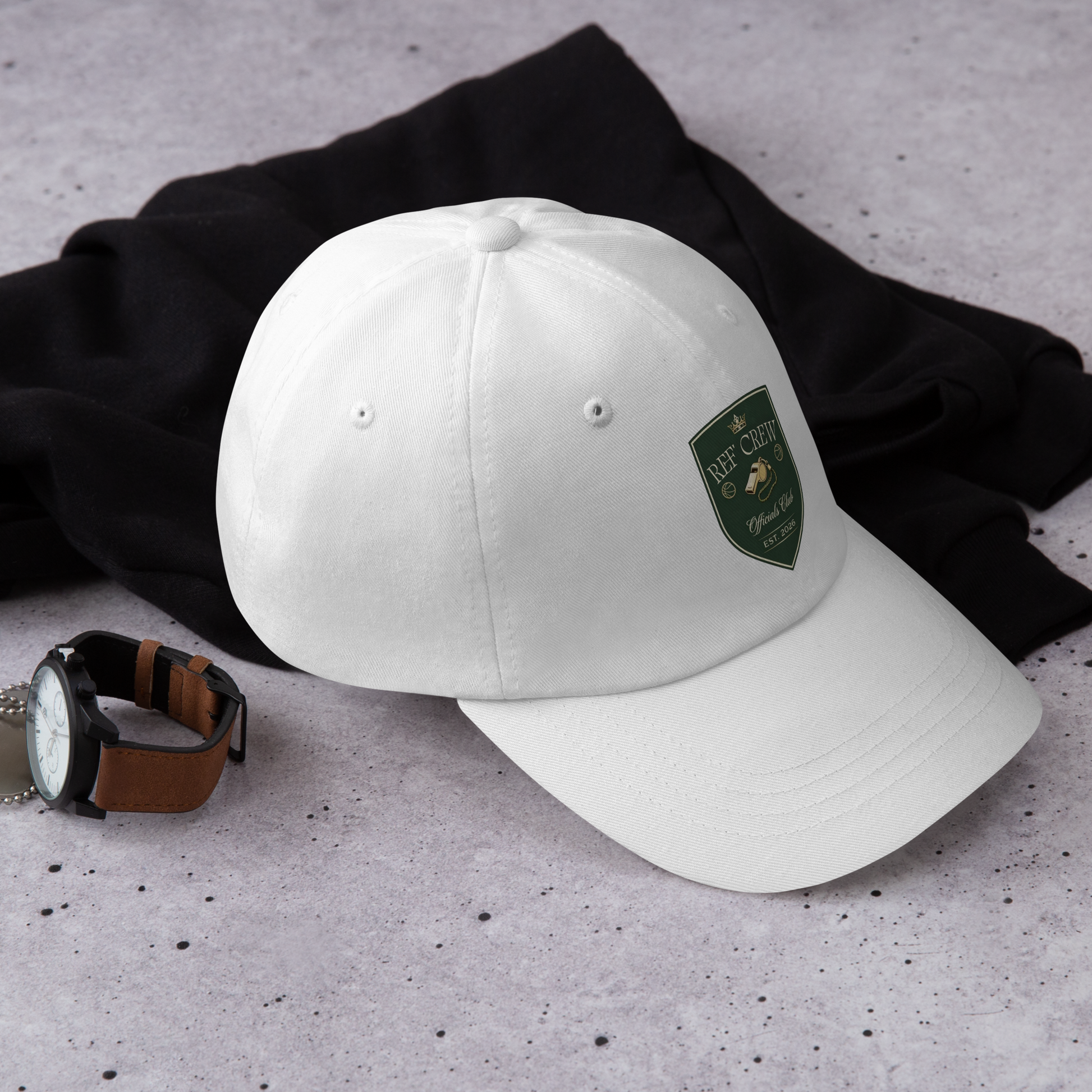 White chino cotton twill dad cap with a green and gold Ref' Crew Officials Club shield logo.