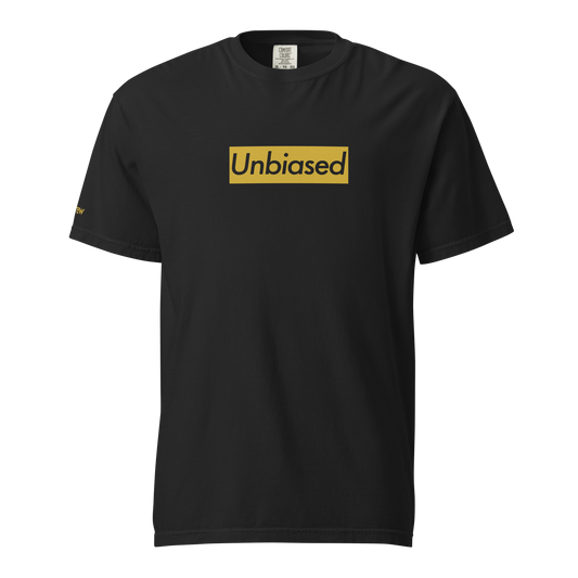 Black garment-dyed heavyweight tee, front view — gold block across the chest with UNBIASED set in italic knocked out of the color
