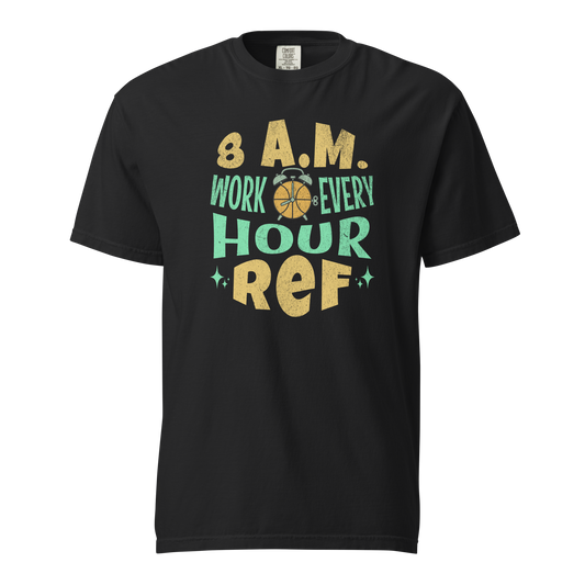 Black garment-dyed heavyweight tee, front view — hand-lettered retro 8 A.M. WORK EVERY HOUR design in mustard gold and mint green around a basketball alarm-clock icon