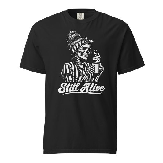 Still Alive Tee in Black – front view, skeleton referee with a messy bun and striped headband holding a steaming coffee, "6 GAMES. 3 GYMS. ONE COFFEE. Still Alive" – Ref' Crew basketball referee tee