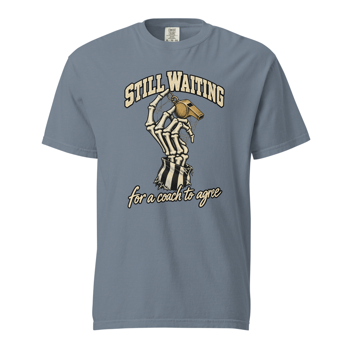 Still Waiting Tee in Blue Jean – front view, skeleton hand holding a cobwebbed gold whistle under "STILL WAITING" – Ref' Crew basketball referee Halloween tee