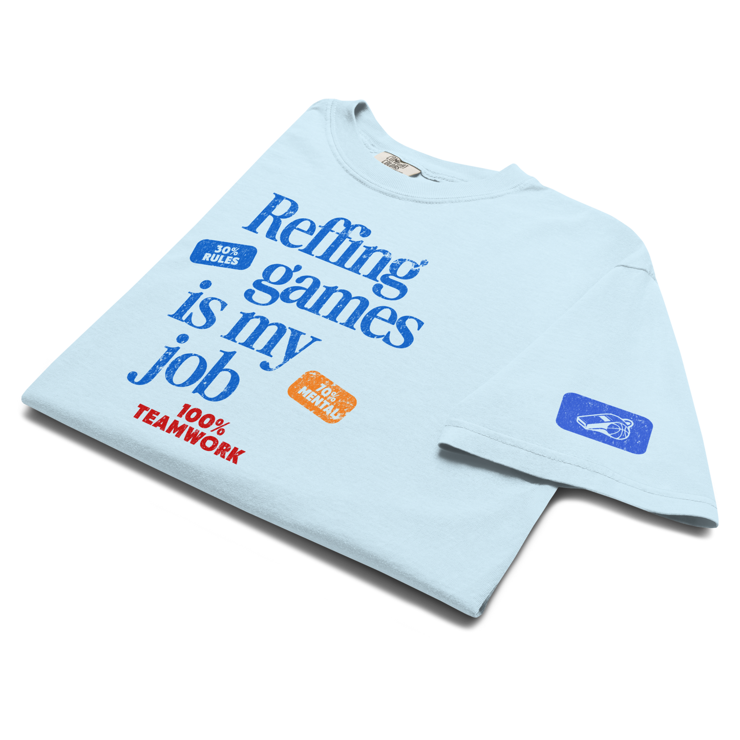 Light blue "Manifesto" Performance Tee with "Reffing games is my job" text, Blue Whistle icon, and premium ring-spun cotton.