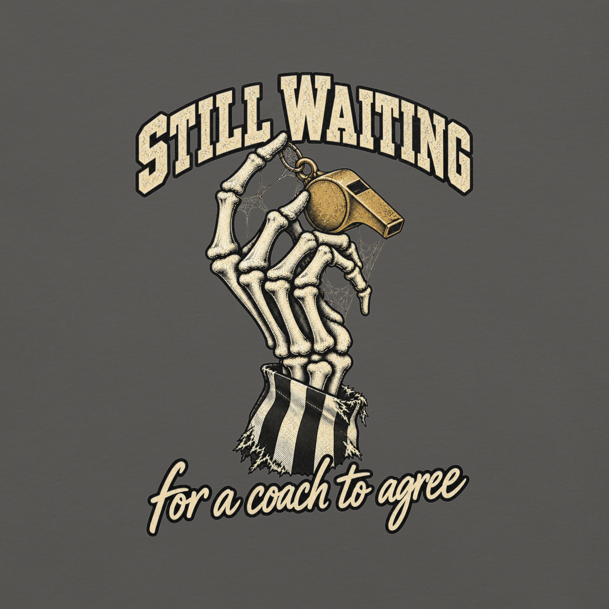 Close-up of the skeleton hand, cobwebbed gold whistle and striped referee sleeve with "STILL WAITING / for a coach to agree" printed on Pepper garment-dyed heavyweight cotton