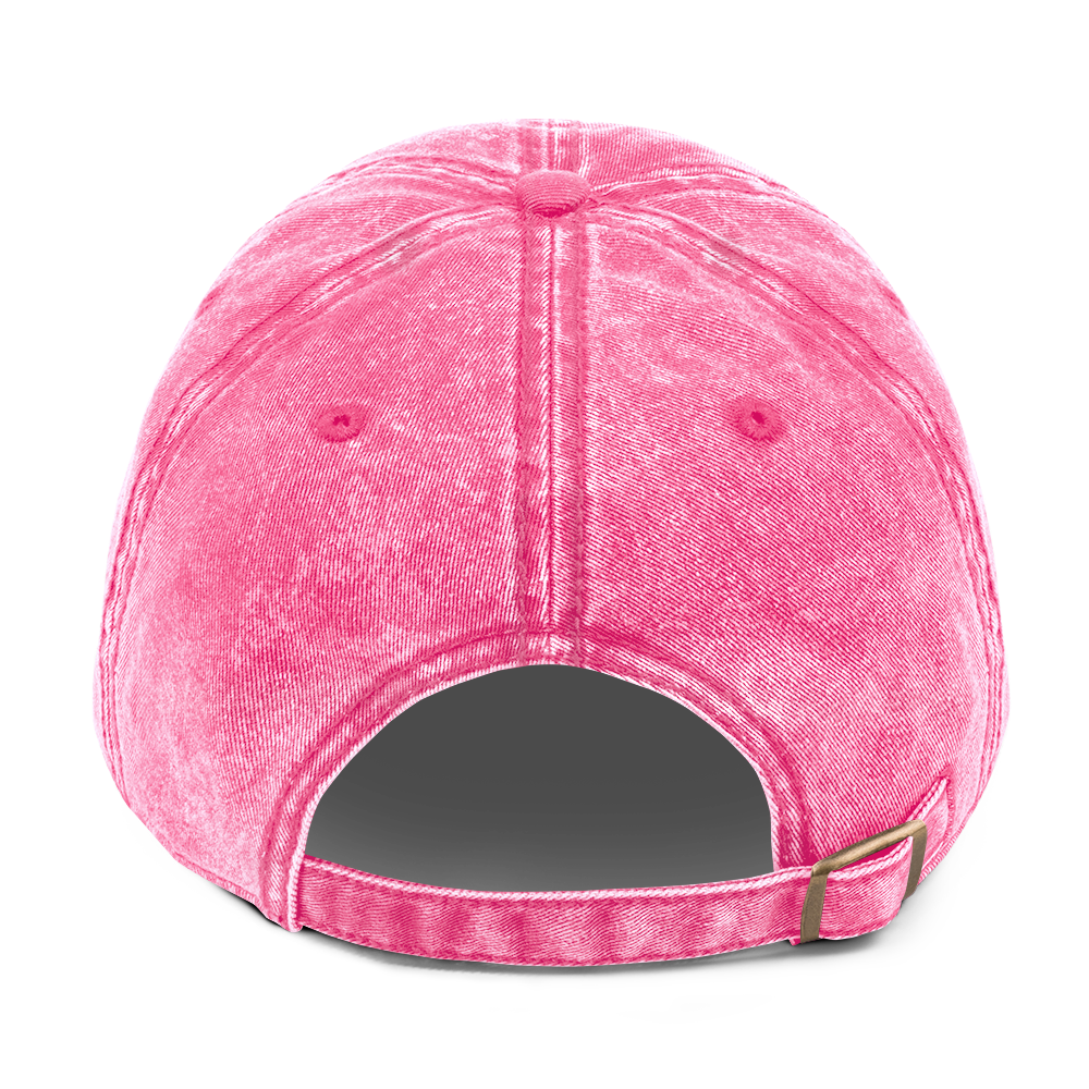 Back view of a washed pink cotton dad cap with an adjustable brass buckle strap, showcasing its vintage texture.